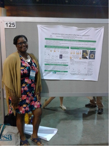 Alicia presenting a poster at a conferece